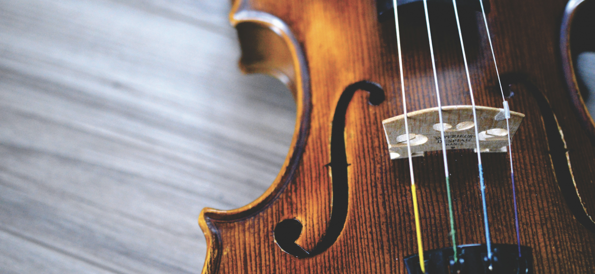 A violin placed on a wooden table